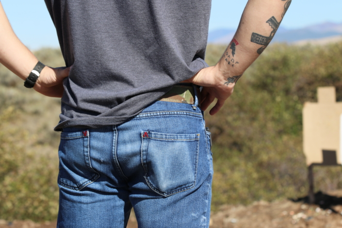 Model wearing Dominate Defense belt